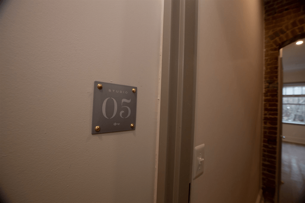 the light switch on the wall of a room with the door open